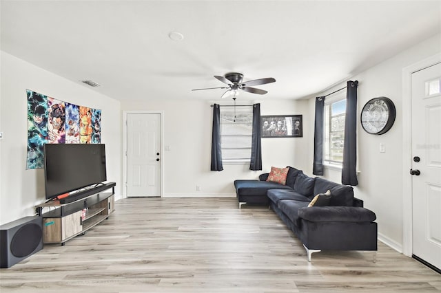 living room with ceiling fan and light hardwood / wood-style flooring