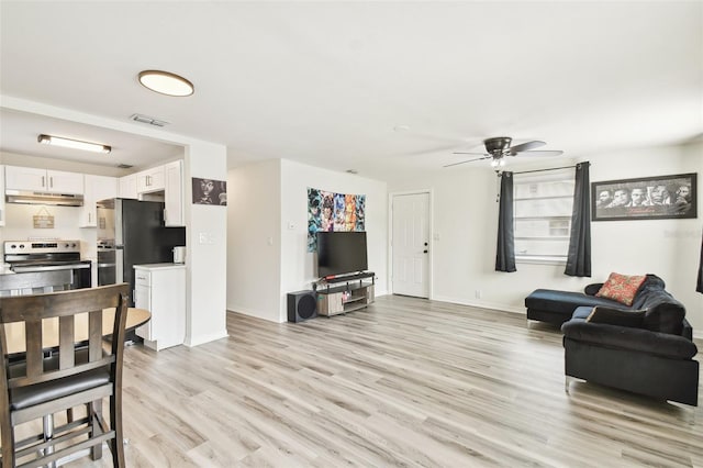 living room featuring light wood-type flooring and ceiling fan