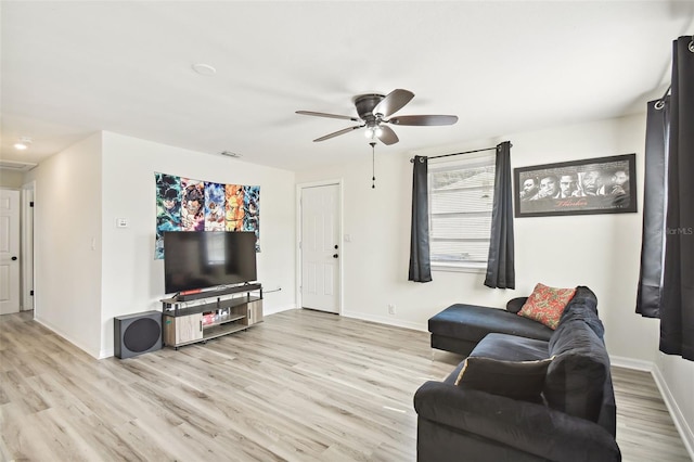 living room featuring light wood-type flooring and ceiling fan