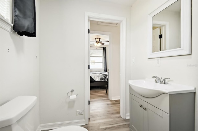 bathroom featuring vanity, hardwood / wood-style floors, toilet, and ceiling fan