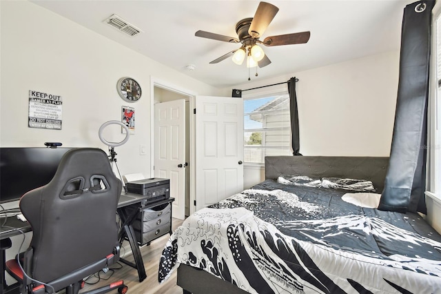 bedroom featuring light hardwood / wood-style floors and ceiling fan