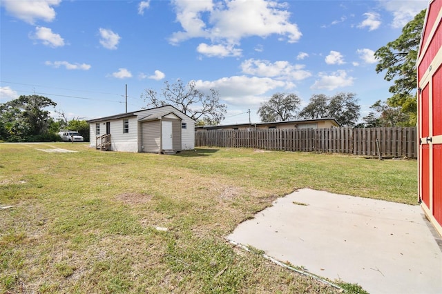 view of yard featuring a patio and a storage unit