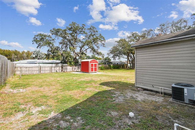 view of yard with a storage unit and central AC