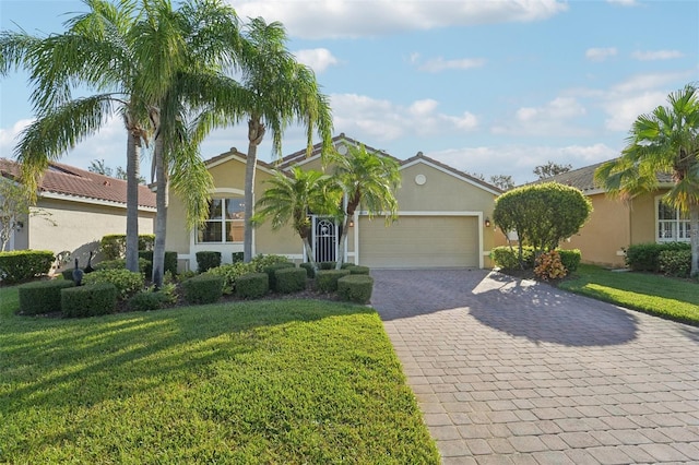 view of front facade with a front yard and a garage