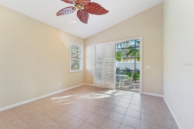 unfurnished room with ceiling fan, lofted ceiling, and light tile patterned floors