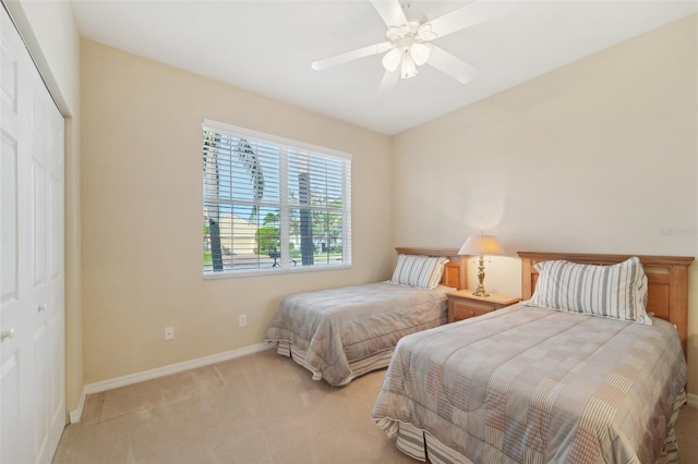 carpeted bedroom featuring a closet and ceiling fan