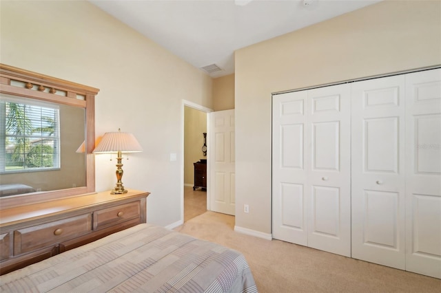 bedroom featuring light carpet and a closet