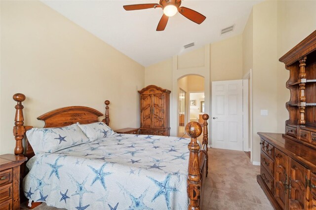 carpeted bedroom with high vaulted ceiling and ceiling fan