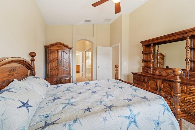 carpeted bedroom with high vaulted ceiling and ceiling fan