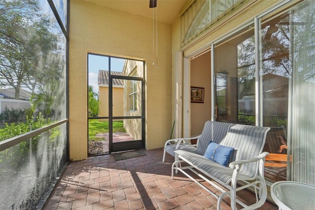 sunroom / solarium featuring ceiling fan