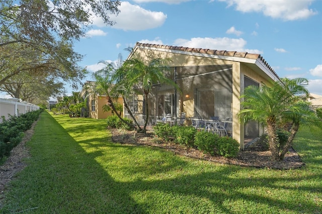 exterior space with a yard and a sunroom