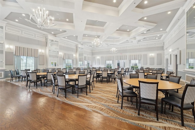 dining space with beam ceiling, hardwood / wood-style flooring, coffered ceiling, and a wealth of natural light