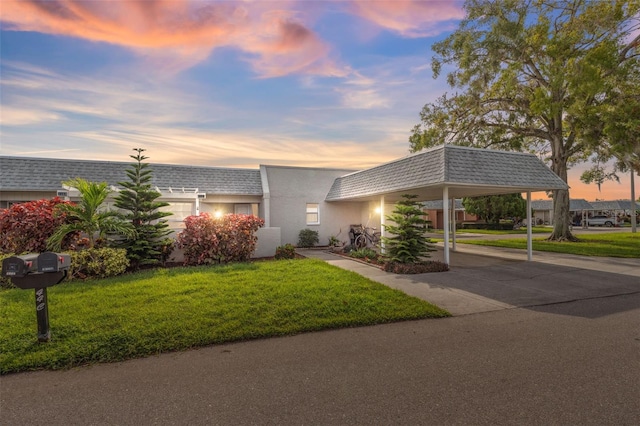 view of front of house with a lawn and a carport