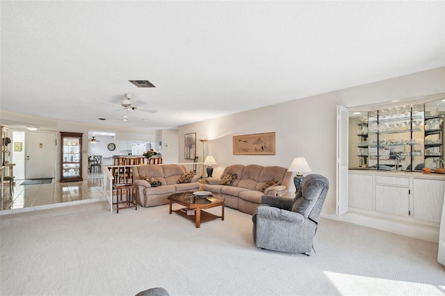 living room with light carpet and ceiling fan