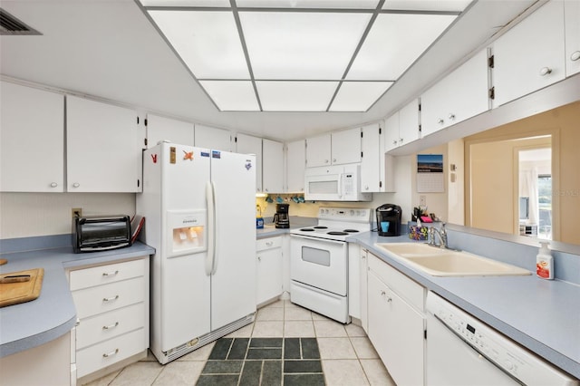 kitchen featuring white cabinets, white appliances, sink, and light tile patterned flooring