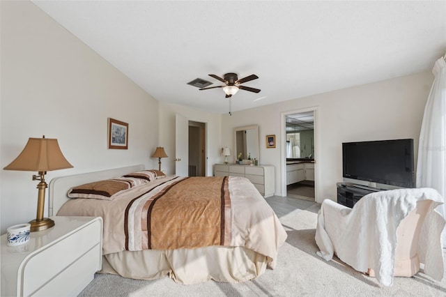 carpeted bedroom with ceiling fan and connected bathroom