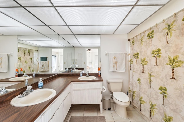 bathroom with toilet, vanity, ceiling fan, and tile patterned floors