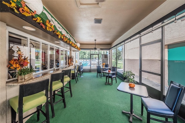 sunroom featuring ceiling fan