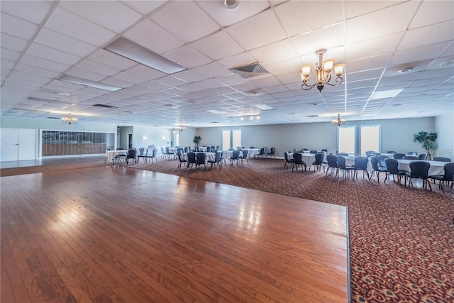 exercise room with hardwood / wood-style floors and a paneled ceiling