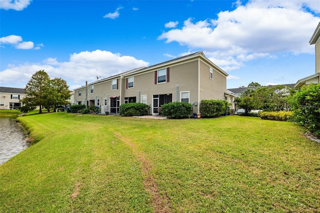 back of property featuring a lawn