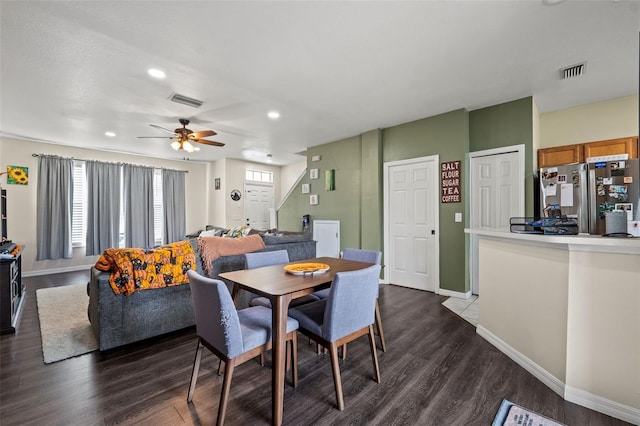 dining room with ceiling fan and dark hardwood / wood-style flooring