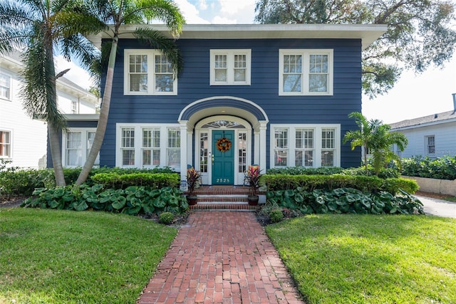 colonial inspired home with a front yard