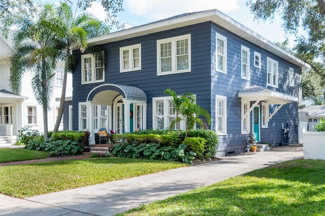 colonial house featuring a front lawn