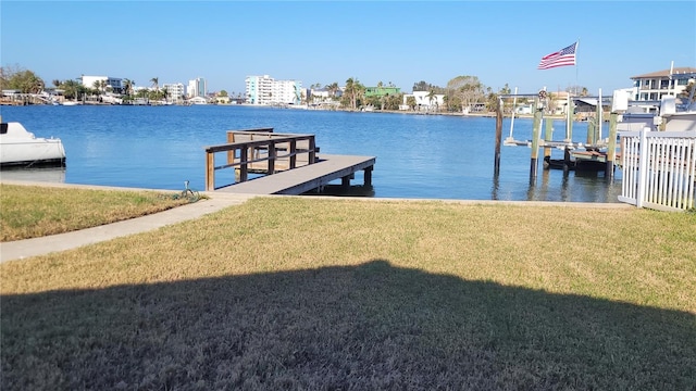 dock area featuring a lawn and a water view