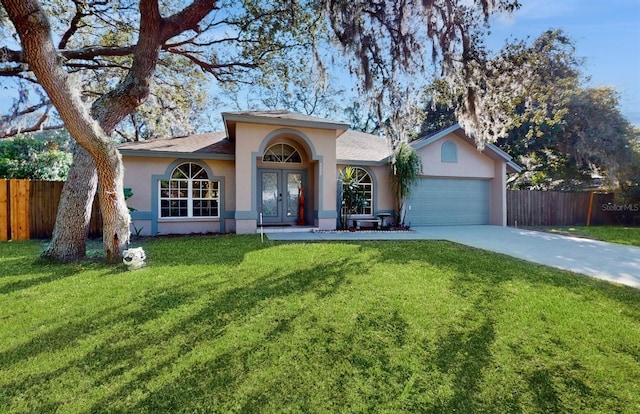 single story home featuring a front lawn and a garage