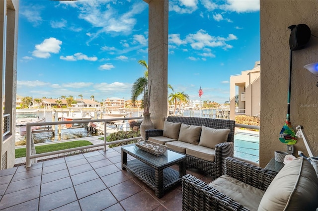 balcony with an outdoor living space and a water view