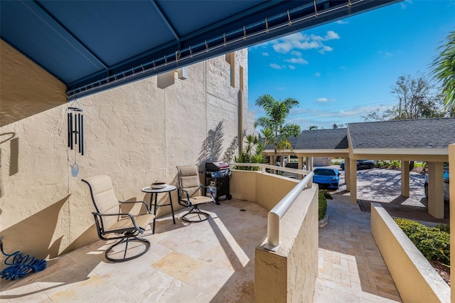 view of patio / terrace with a balcony and grilling area