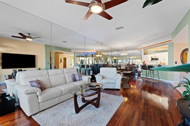 living room with ceiling fan and dark hardwood / wood-style floors