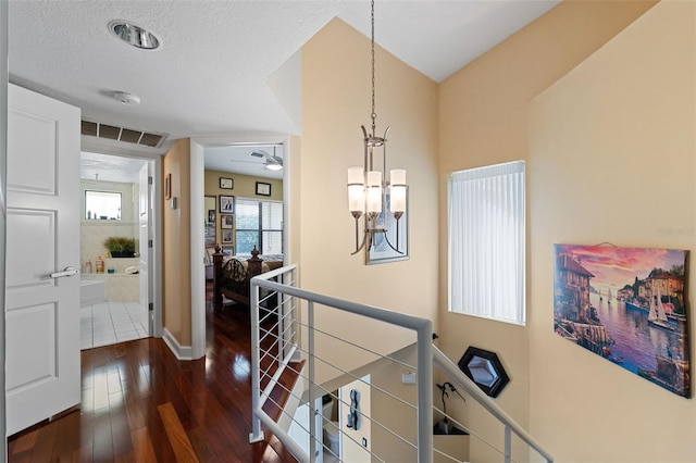 hallway featuring dark wood-type flooring and a textured ceiling