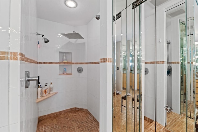 bathroom with tile patterned flooring, a textured ceiling, and an enclosed shower