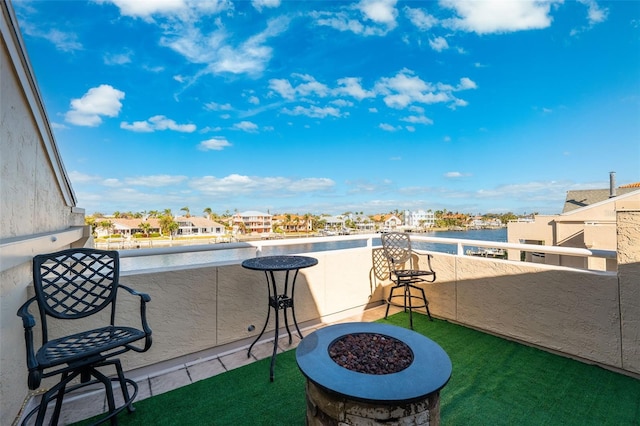 view of patio featuring a fire pit and a balcony