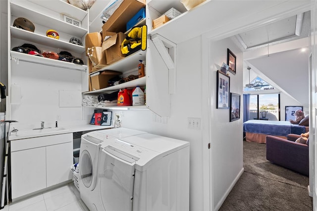 washroom with cabinets, light colored carpet, independent washer and dryer, and sink