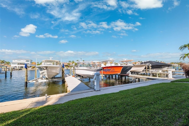 dock area featuring a lawn and a water view