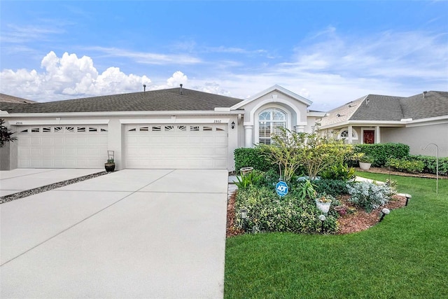 ranch-style home with a front lawn and a garage