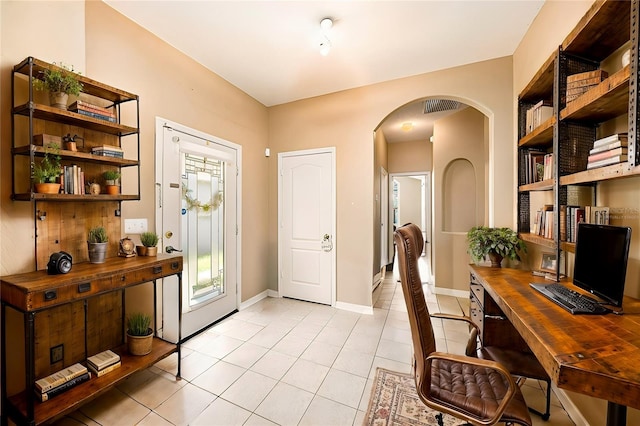 office with built in desk and light tile patterned flooring