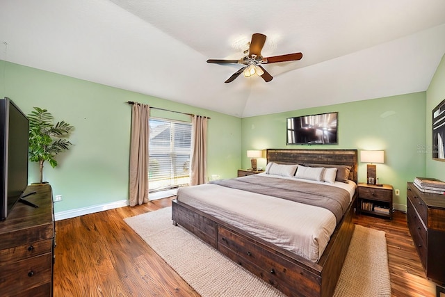 bedroom featuring dark wood-type flooring, ceiling fan, lofted ceiling, and baseboard heating