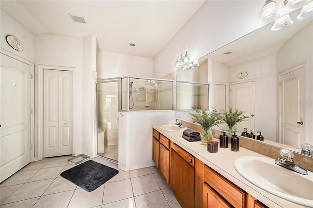 bathroom with vanity, tile patterned floors, and a shower with shower door