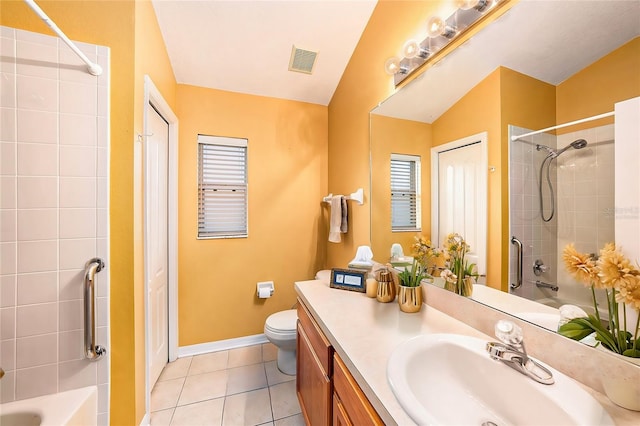 full bathroom featuring toilet, tile patterned floors, vaulted ceiling, vanity, and tiled shower / bath combo