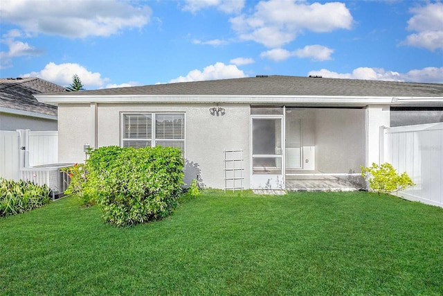 rear view of house featuring a yard, a patio, and cooling unit