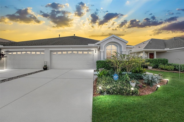 view of front of home featuring a yard and a garage