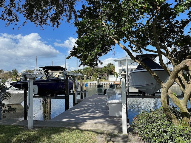 dock area with boat lift and a water view