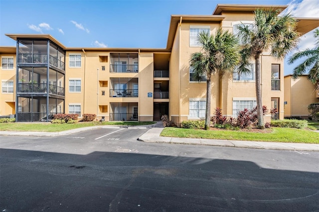 4323 Bayside Village Dr Unit 105, Tampa, FL 33615 - view of apartment building / complex featuring uncovered parking