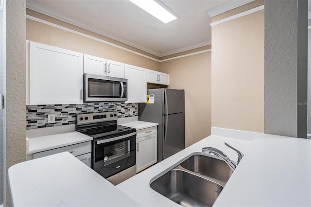 4323 Bayside Village Dr Unit 105, Tampa, FL 33615 - kitchen with stainless steel appliances, crown molding, a sink, backsplash, and white cabinetry