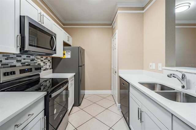 4323 Bayside Village Dr Unit 105, Tampa, FL 33615 - kitchen with appliances with stainless steel finishes, a sink, ornamental molding, tasteful backsplash, and light tile patterned flooring