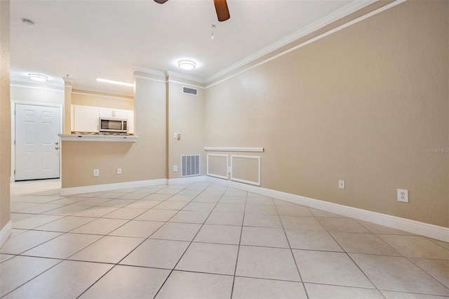 4323 Bayside Village Dr Unit 105, Tampa, FL 33615 - unfurnished room with ornamental molding, a ceiling fan, light tile patterned floors, baseboards, and a smoke detector
