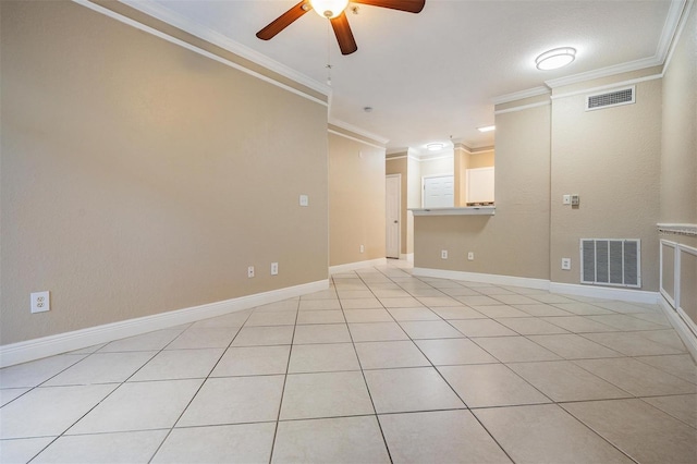 4323 Bayside Village Dr Unit 105, Tampa, FL 33615 - spare room with crown molding, ceiling fan, light tile patterned flooring, and baseboards